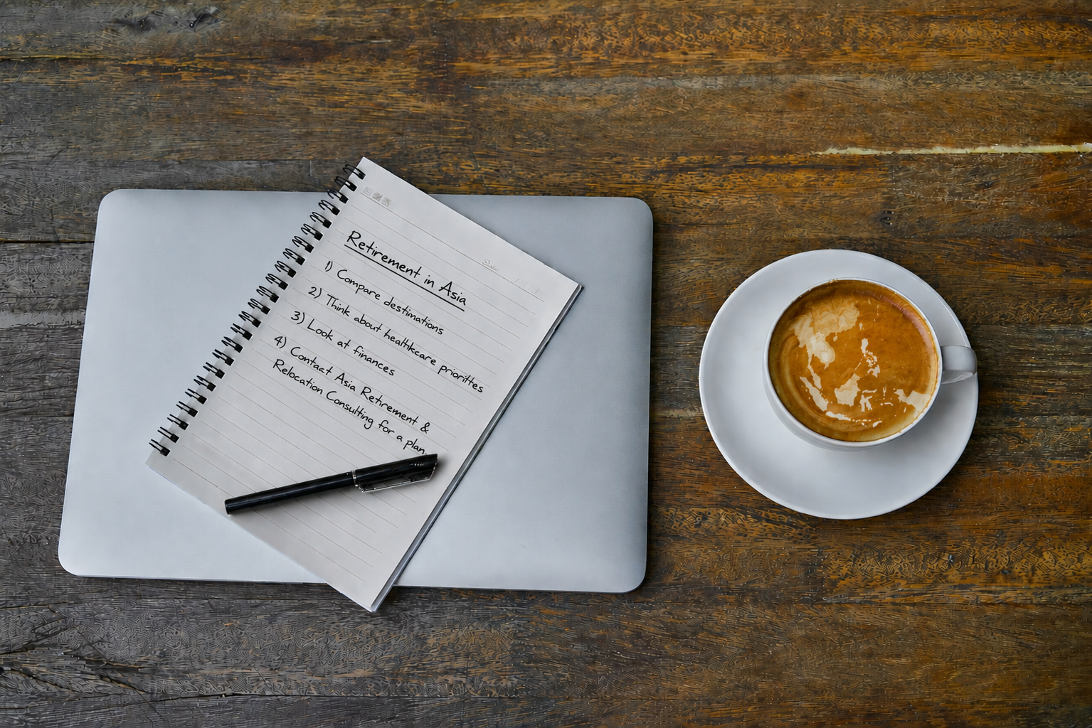 Notebook, pen and coffee for a planning conversation
